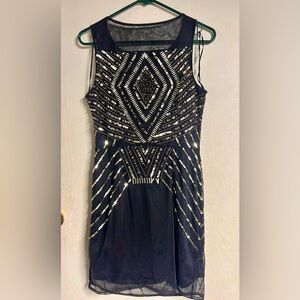 Sexy black sheer layered dress with gold embellishments. Size 10. Used twice